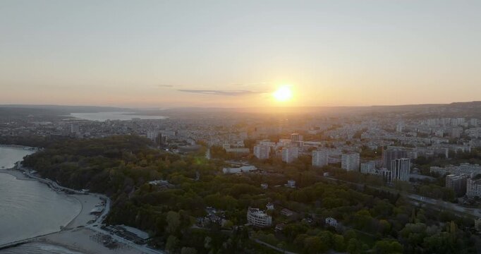 Drone shot Chaika neighborhood Varna Bulgaria sunset light. Cityscape residential buildings urban architecture sea horizon background. Summer evening aerial perspective.