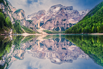 Lago di Braies, Italy. Alpine lake with emerald waters, dramatic Dolomites peaks, wooden boats, and breathtaking scenic beauty.