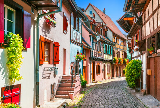 Eguisheim, Alsace - France. Picturesque village with colorful half-timbered houses, cobblestone streets, flower-filled balconies and scenic vineyards