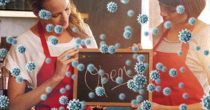 Animation of virus cells over happy caucasian waitresses with open sign