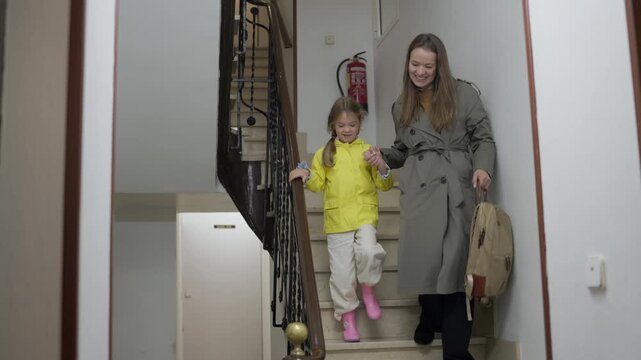 Mother and daughter sharing a goodbye moment before beginning the school day