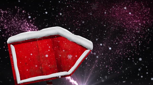 Animation of snow falling at christmas over wooden sign