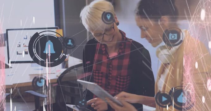 Animation of icons and data processing over diverse business people using tablet