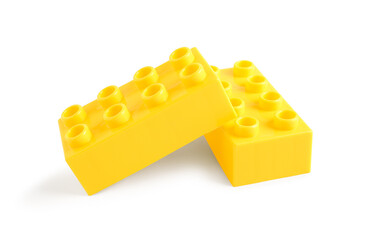 Yellow plastic building blocks on white background