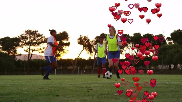 Soccer ball rolling and attacker dribbling floating hearts defender sliding and referee entering