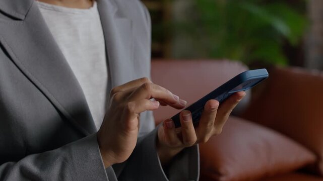Businesswoman Using Smartphone for Online Browsing