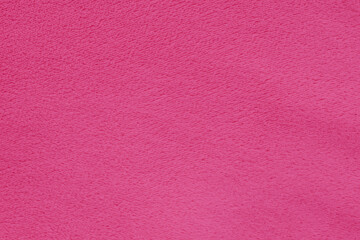Macro photo of a soft pink microfiber texture. The close-up reveals a dense, fuzzy fiber structure with gentle light transitions, creating a velvety and tactile surface © moryachka