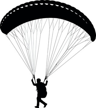 Silhouette of a person paragliding with a parachute