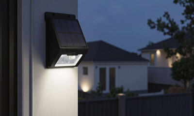 Obraz premium Solar security light mounted on wall provides bright led illumination at night in a suburban residential neighborhood for home safety