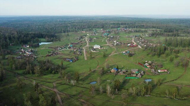 Southern Urals in spring: mountainous Bashkir village of Kyzlar-Birgan. Aerial view.