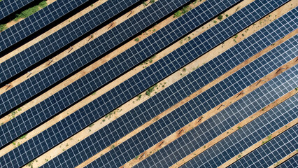 A high angle top-down aerial view showing the geometric pattern of diagonal rows of photovoltaic...