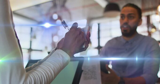 Animation of light spots over man ordering in cafe