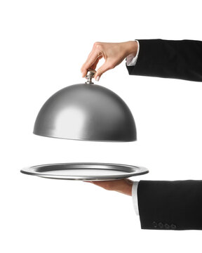 Hands of waitress with silver tray and open cloche on white background