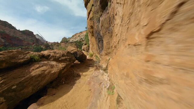 Footage capturing the scenic narrow pathway and stunning panoramic views along the Canyon Overlook Trail in Zion National Park, Utah, USA. This popular, easy-to-moderate hike offers spectacular scener