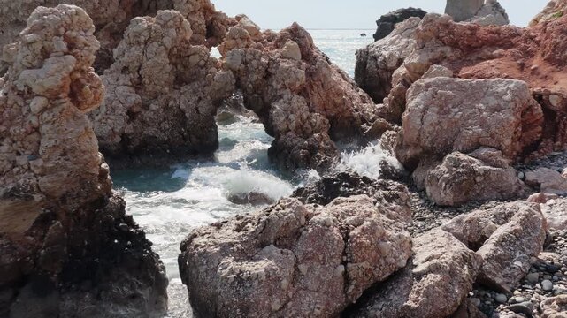 Aerial drone view of Aphrodite's Rock with turquoise sea and nearby coastal road, one of Cyprus' most famous natural landmarks