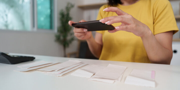Woman scanning receipts with smartphone