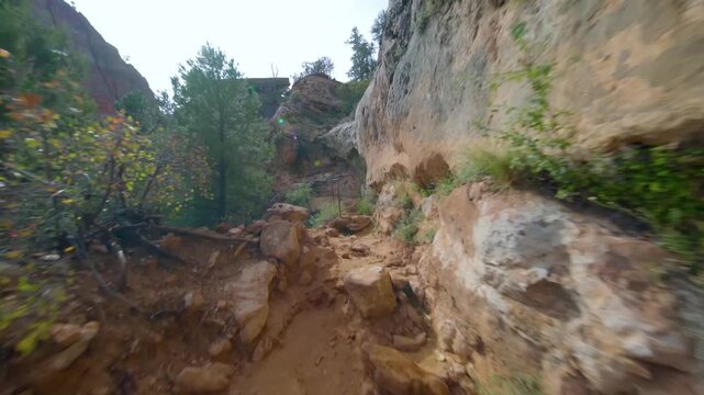 Footage capturing the experience of hiking the popular and relatively short Canyon Overlook Trail in Zion National Park, Utah. The trail features a rugged, rocky path, natural stone steps, and offers 