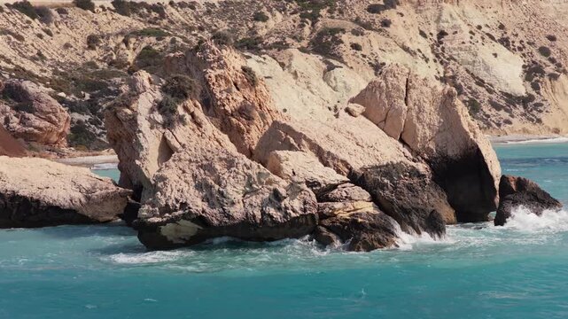 Aerial drone view of Aphrodite's Rock surrounded by bright blue Mediterranean water