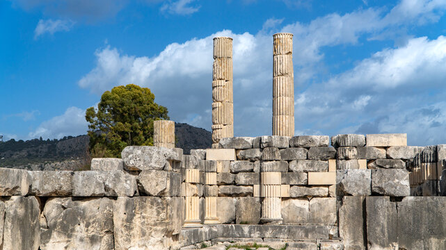 Ancient stone gateway at Letoon sanctuary, featuring arched entrance, weathered walls and pathway leading into historic Lycian ruins near city of Xanthos