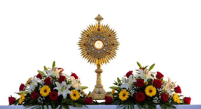 A golden monstrance with a cross on top surrounded by vibrant flowers on an altar