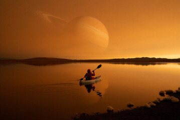 Fototapeta premium Man kayaking on calm lake at sunset minimal landscape