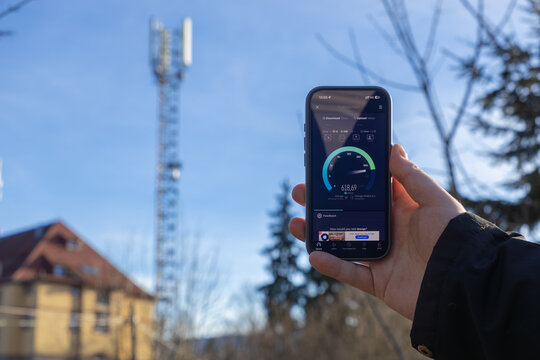 Szklarska Poreba, Poland - December 16, 2025: Hand holding smartphone displaying SPEEDTEST with high download speed, illustrating modern 5G network performance