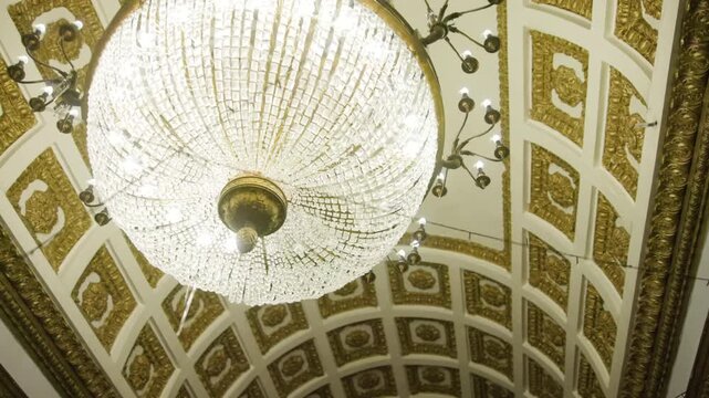 Elegant Chandelier With Gold Accents. Creative. Ornate Crystal Fixture Illuminating Historic Ballroom Space
