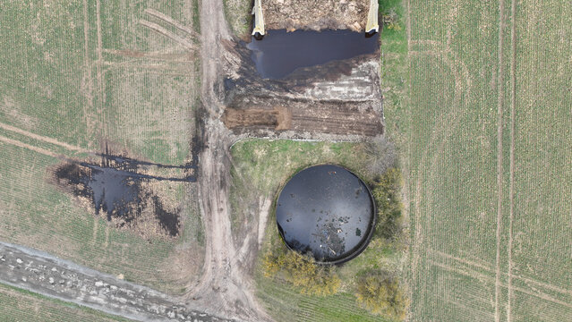 Manure lagoon storage tank pit submerged slurry collect and store liquid livestock pollution contamination groundwater solid waste bedding straw or corn stalks stored pile stinking unpleasant smell