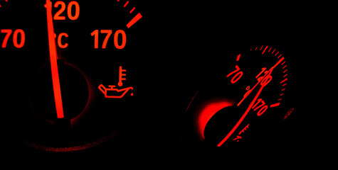 Oil temperature indicators in a car dashboard isolated on black background
