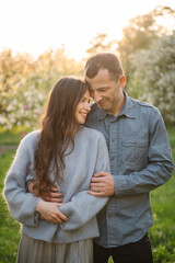 Fototapeta premium Authentic portrait of happy husband and wife smiling and cuddling outdoors.
