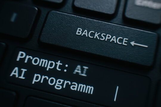 Prompt ai programmer creating code on keyboard screen with backspace key and glowing text conveying focused technical mood