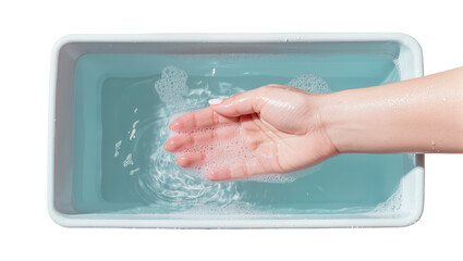 Fototapeta premium Pale skin hand submerged in turquoise water, creating ripples and bubbles