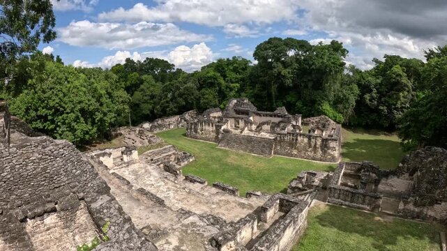 Scenic view of Mayan temple complexes in Tikal surrounded by dense rainforest, atmospheric travel and history footage Guatemala