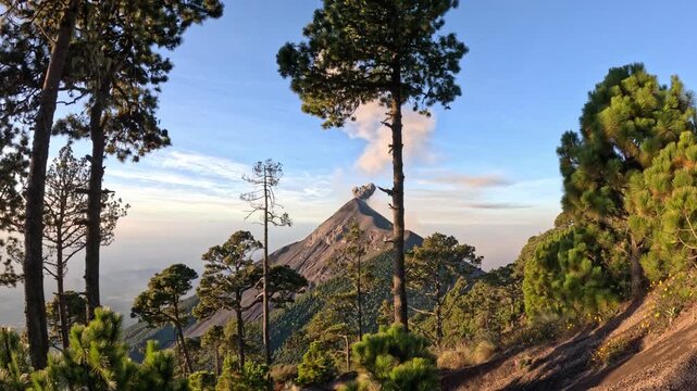 Cinematic eruption of Volc&aacute;n de Fuego at sunrise seen from Acatenango volcano, dramatic lava explosions and ash plume over Guatemala volcanic landscape