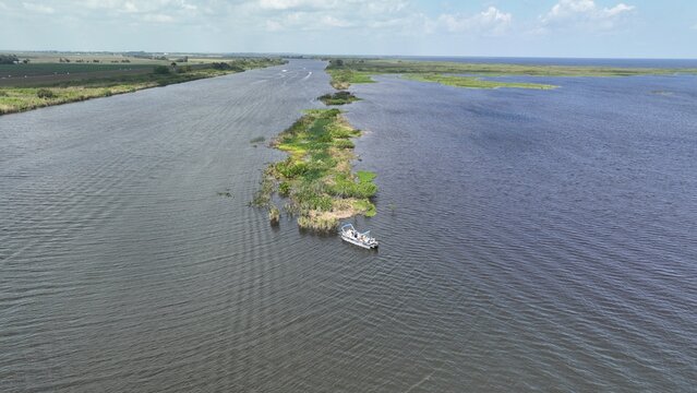 Aerial view of a boat sailing by a small island in the middle of a river, Lake Okeechobee, Florida, United States.