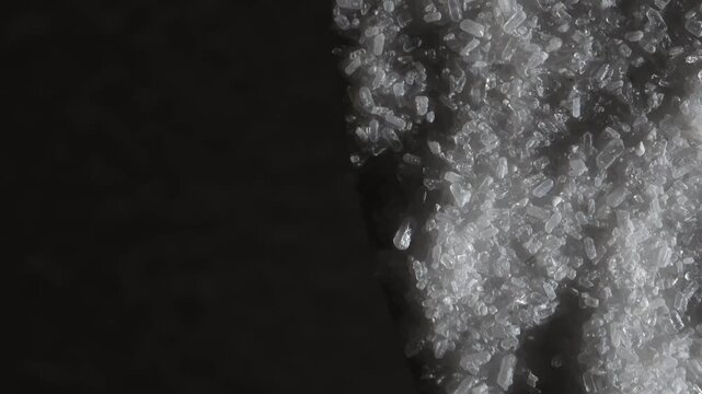 Epsom salt. Salt. Black background. Slow motion video. High quality 4k footage
