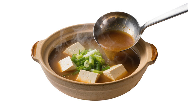 Rustic ceramic bowl holding steaming miso soup, ladled with silver spoon