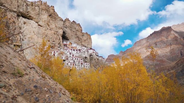 Beautiful landscape of Phugtal monastery in remote Himalayan mountains with autumn trees. Ancient Tibetan Buddhist Phuktal monastery of on a steep rocky mountain in Zanskar, Ladakh, India.  