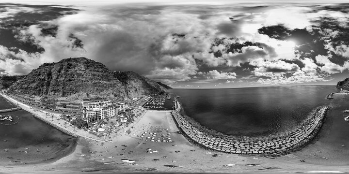 Panoramic drone perspective over Recreio da Calheta showing harbor, seaside promenade, and Atlantic coastline landscape