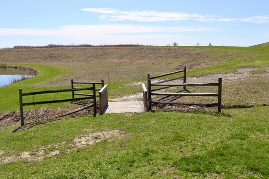 The wood bridge in the field on a sunny day.