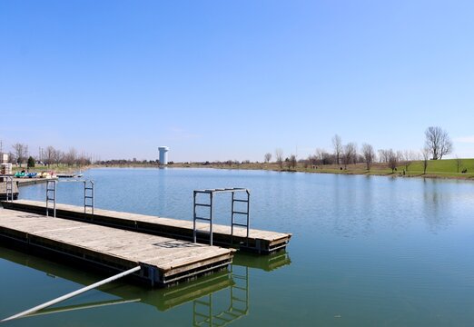 The wood dock at the lake on a sunny day.