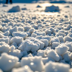 Obraz premium The photo showcases a vast expanse of snow in a frozen state, with numerous ice crystals scattered across it