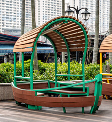 modern colorful wooden urban seating structure in public park representing contemporary outdoor design. creative architectural installation in metropolitan environment