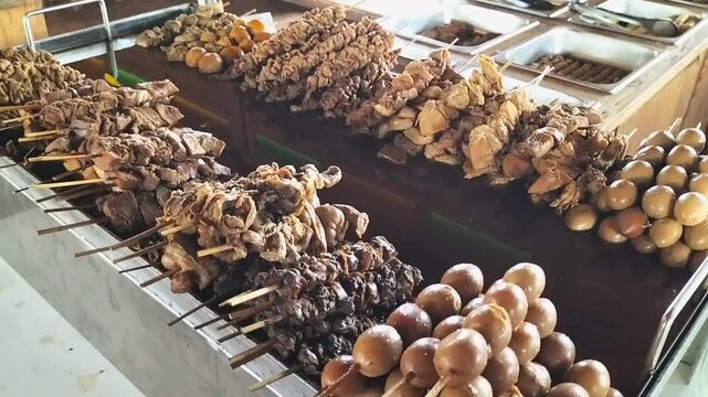Various kinds of satay sticks in gray containers. One of tradisional food from Central Java, Indonesia. Footage. 