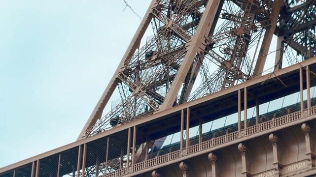 Eiffel Tower Architectural Detail with Silhouetted People Walking on Observation Deck Stairs in Paris
