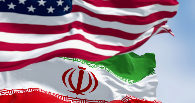 USA and Iran flags waving together.