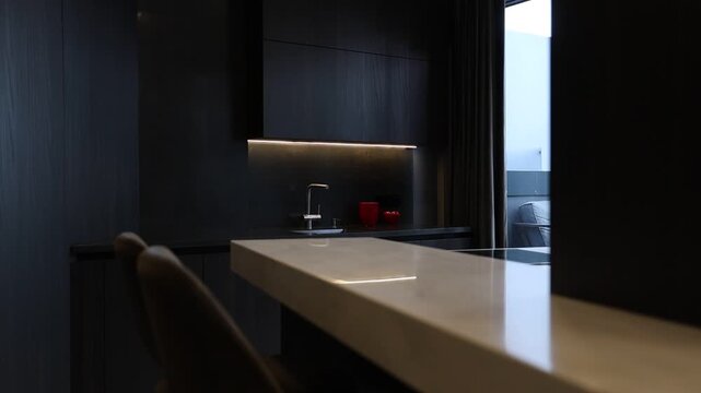 Stylish dark kitchen island featuring sink and cozy ambiance