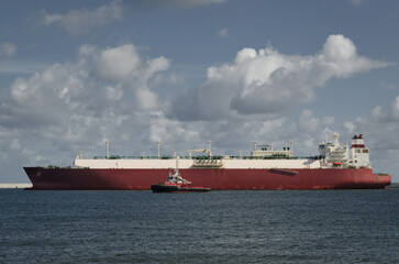 LNG TANKER - The ship sails out from the port to the sea 