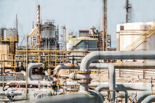 Industrial pipes and valve system inside refinery with metal structures and processing equipment. War Iran. Problems with oil supply, logistics. Petrochemical plant site. Kuwait, Hormuz, Kharg