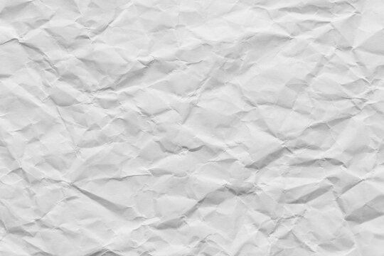 Crumpled white paper texture background, Top view of wrinkled paper sheet,macro,Close-up of a white crumpled paper texture background. Highly detailed wrinkled surface of empty paper sheet with shadow